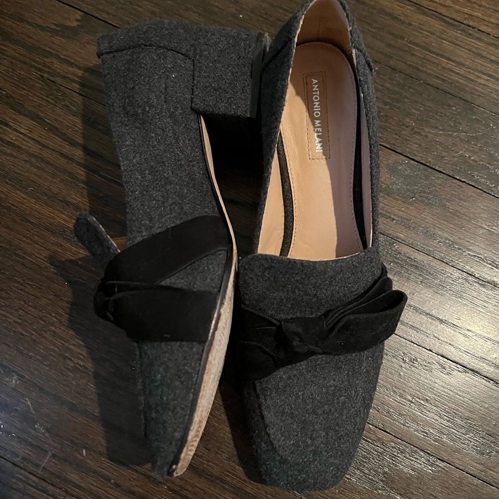 Gently worn gray loafer with black bow. Has a low heel.